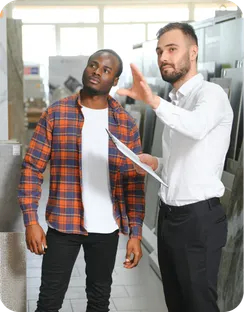 A salesman shows a customer around a store.
