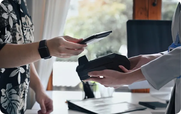 A customer paying by phone at a card reader.