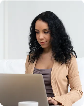 A woman works on a laptop.