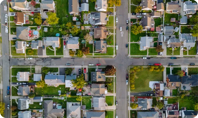 An aerial view of a suburban neighborhood laid out in a grid of streets.