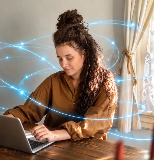A woman with curly hair smiles at her laptop, with lines of light circling her.
