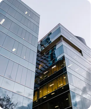 Glass office towers seen from below on an overcast day.