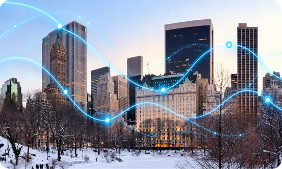 A snowy city park below skyscrapers, with glowing lines of data over it.