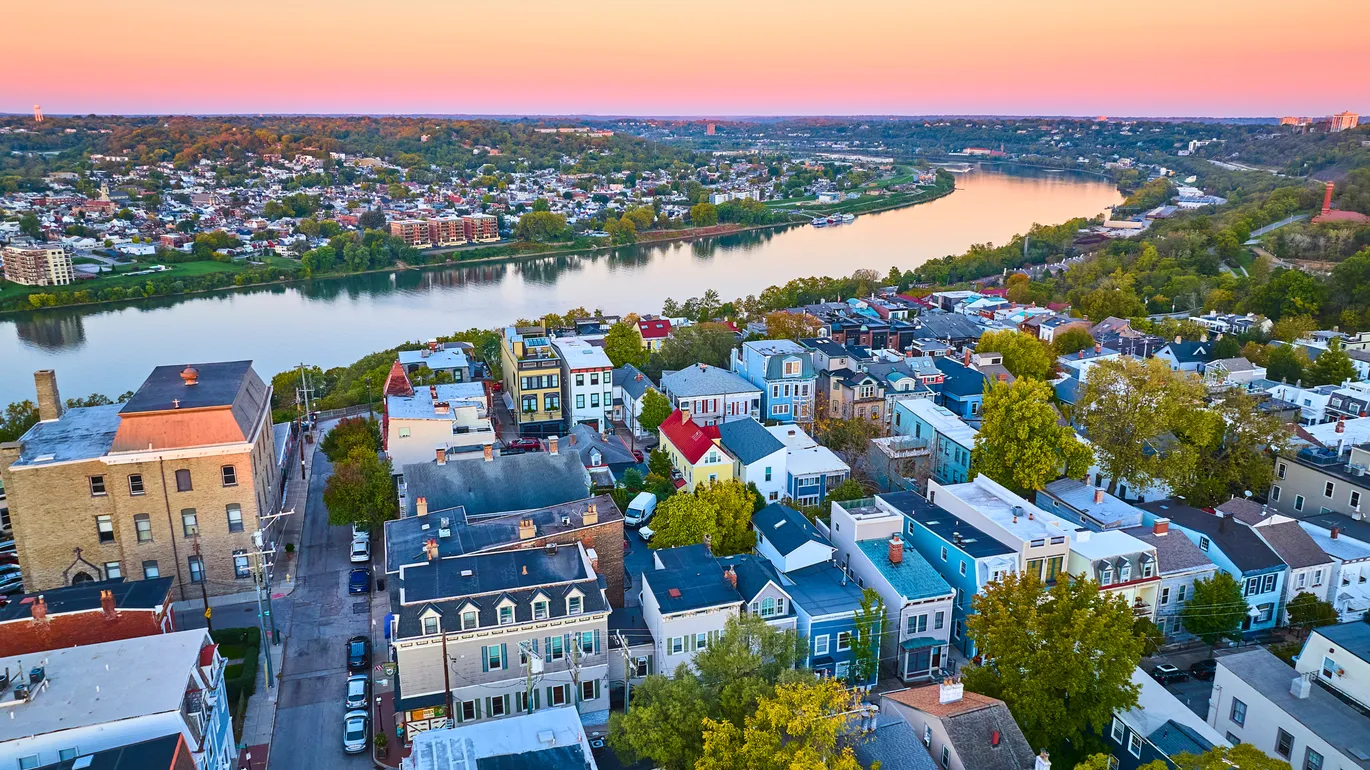 An aerial view of a riverside town at sunset.