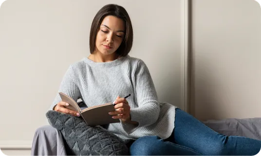 A woman reading at home, relaxed.