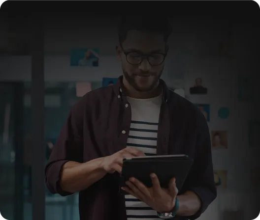 A man reading on a tablet.