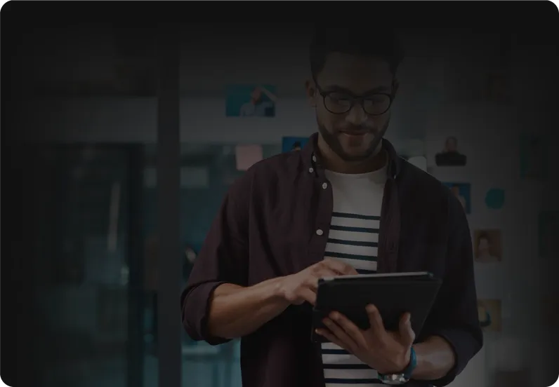 A man reading on a tablet.