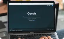 A laptop open to the Google search page.